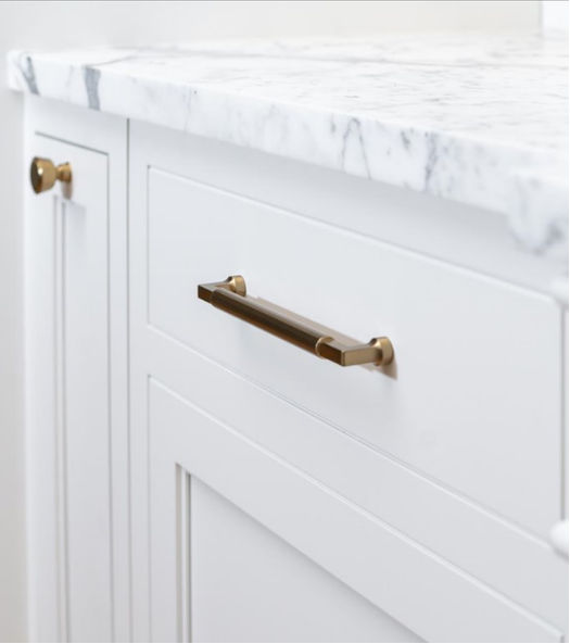 Inset drawer front with marble countertop and brass pull